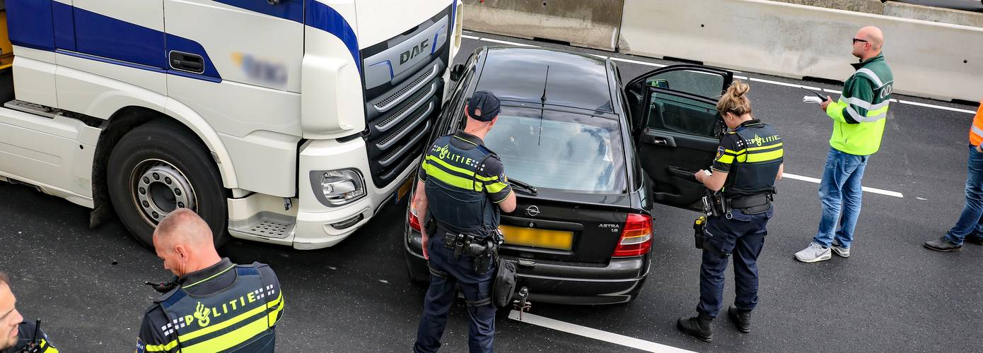 Vrachtwagen en auto botsen op ringweg; lange file tot gevolg